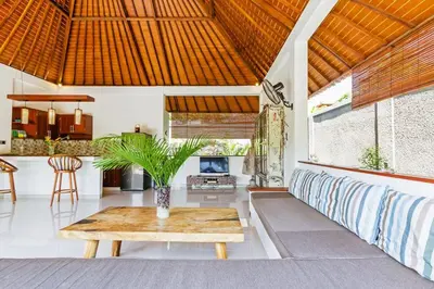 a living room with a table and a couch at Awesome 1BR Villa in the heart of Seminyak in Seminyak