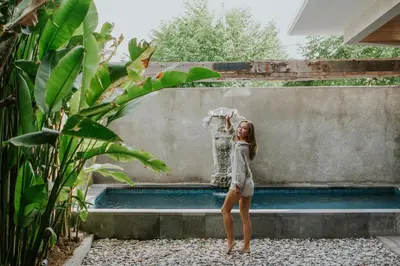 a young girl standing in front of a fountain at Kuta Legian Villa 3 Bedroom Private pool in Legian