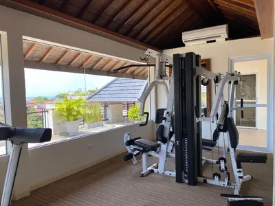 a fitness room with a gym with a window at Stylish 2 Bedroom Penthouse Apt, Newly Refreshed, 50 Mbps, Pool, Gym, Resto in Kuta