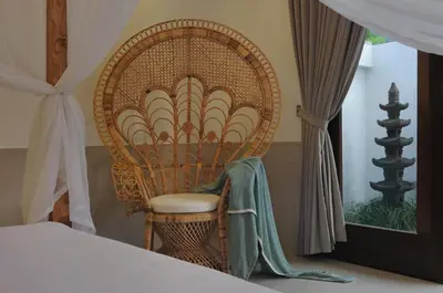 a wicker chair sitting next to a bed in a bedroom at 3BR Villa Olli - Minggu Villas -Special Stay Bonus in Kerobokan