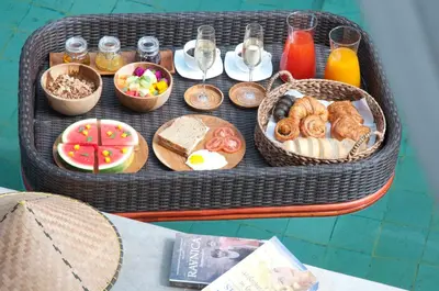 a table with a tray of breakfast foods and drinks at 3BR Villa Olli - Minggu Villas -Special Stay Bonus in Kerobokan