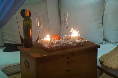 a table with candles and wine glasses and a bottle at 2BR Villa Michelle - Minggu Villas - Special Stay Bonus in Kerobokan