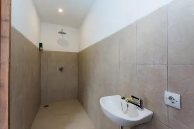 a bathroom with a sink and a shower at Radea Villa in Kerobokan