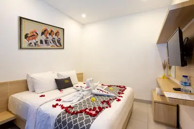 a hotel room with a bed with flowers on it at Radea Villa in Kerobokan