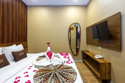 a hotel room with a bed and a mirror at Radea Villa in Kerobokan