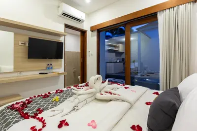 a bedroom with a bed with red roses on it at Radea Villa in Kerobokan