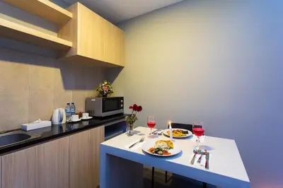 a kitchen with two plates of food and wine glasses at Radea Villa in Kerobokan