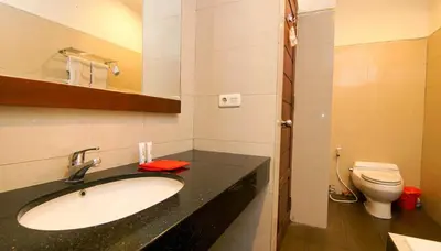 a bathroom with a sink and a toilet at Kuta Paradise 777 in Legian