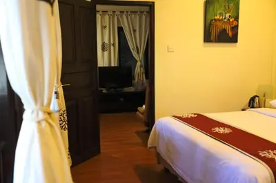 a bedroom with a bed and a television in it at Niramaya Villa in Seminyak