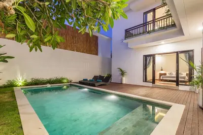 a swimming pool in the middle of a house at Villa Azura in Seminyak