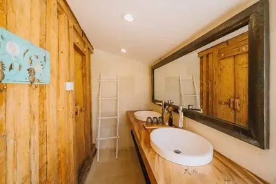 a bathroom with two sinks and a large mirror at Chanteak Bali in Jimbaran