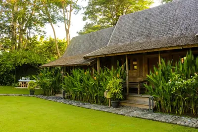 a house with a garden in front of it at Chanteak Bali in Jimbaran