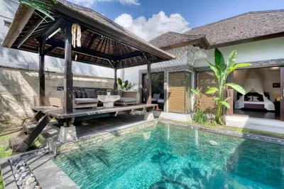 a villa with a swimming pool and a house at Modern Private Villa Atala with Private XL Pool in Seminyak