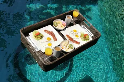 a tray of breakfast food in a swimming pool at Modern Private Villa Atala with Private XL Pool in Seminyak
