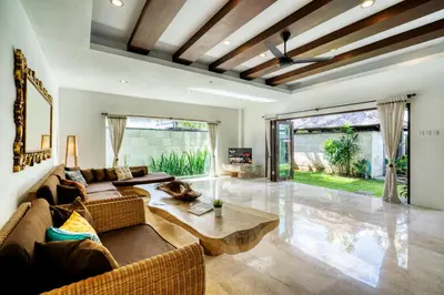 a living room with a couch and a table at Modern Private Villa Atala with Private XL Pool in Seminyak