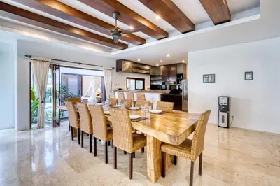 a dining room with a wooden table and chairs at Modern Private Villa Atala with Private XL Pool in Seminyak