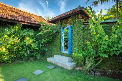 a house with a blue door on the side of it at Villa Janitra in Seminyak