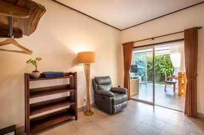 a living room with a chair and a lamp at Villa Janitra in Seminyak
