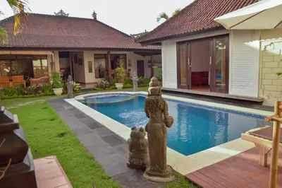 a statue of a bear next to a swimming pool at Tegal Uma Seminyak by Maha Bali in Seminyak