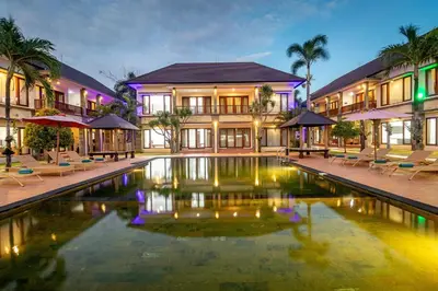 a hotel with a pool in front of a building at Vidi Boutique Hotel in Nusa Dua