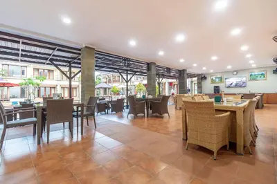 a dining room with tables and chairs and a restaurant at Vidi Boutique Hotel in Nusa Dua