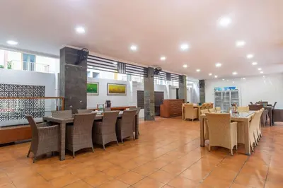 a restaurant with tables and chairs in a room at Vidi Boutique Hotel in Nusa Dua