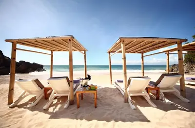 a group of chairs and a table on the beach at RIMBA by AYANA Bali in Jimbaran