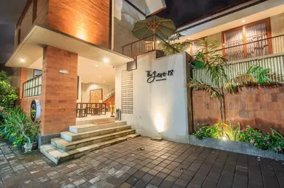 a building with stairs and a wall with writing on it at The jero 18 kuta guest house in Kuta