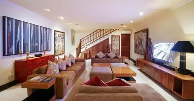 a living room with couches and a flat screen tv at Villa Bali Maja - Beautiful Private Pool Villa in Petitenget, Seminyak in Seminyak