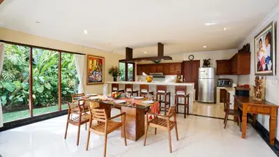 a kitchen and dining room with a table and chairs at Villa Bali Maja - Beautiful Private Pool Villa in Petitenget, Seminyak in Seminyak
