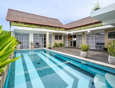 an image of a swimming pool in front of a house at Lolo #2 Apartment by Betterplace in Canggu