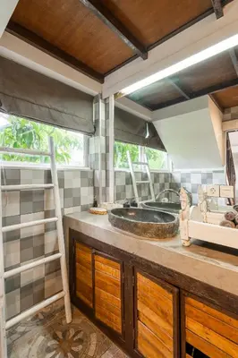 a bathroom with a sink and a ladder at Lolo #2 Apartment by Betterplace in Canggu