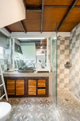 a bathroom with a sink and a glass shower at Lolo #2 Apartment by Betterplace in Canggu