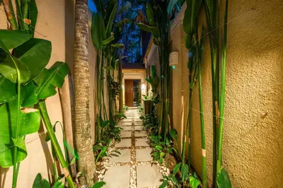 a hallway with plants on the side of a building at Villa Seacluded 1 - 3BR Villa in Central Seminyak - Large Pool in Seminyak