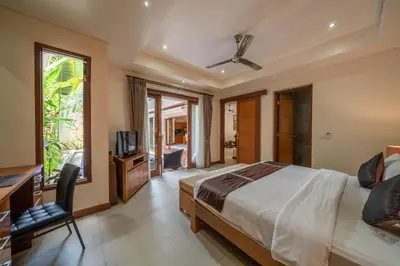 a bedroom with a bed and a television in it at Villa Seacluded 1 - 3BR Villa in Central Seminyak - Large Pool in Seminyak