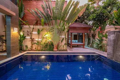 a swimming pool in a garden with a gazebo at Villa Seacluded 1 - 3BR Villa in Central Seminyak - Large Pool in Seminyak