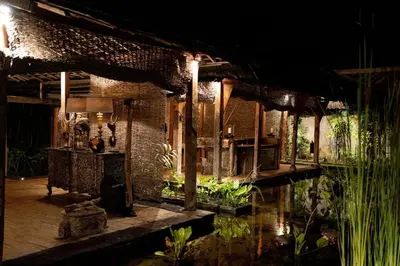a house with a pond in the middle of it at Villa Jasli in Canggu