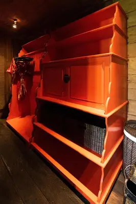 an empty red cabinet with orange shelves at Villa Jasli in Canggu