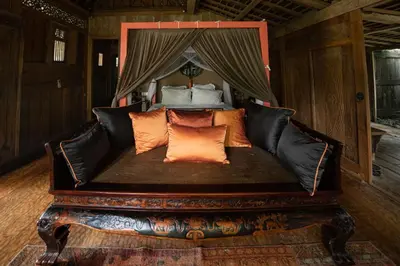 a black couch with orange pillows in a bedroom at Villa Jasli in Canggu