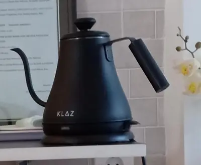 a black tea kettle sitting on top of a table at Simple Kuta Bedroom in Kuta