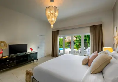 a bedroom with a large white bed and a television at Villa Bloom 4 - 2 King bedrooms , Sleep 4 Pax, private pool, Seminyak in Seminyak