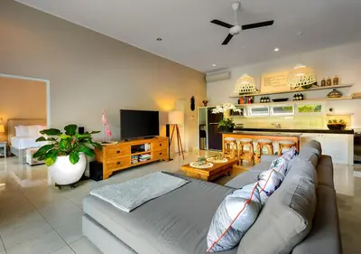 a living room with a couch and a kitchen at Villa Bloom 4 - 2 King bedrooms , Sleep 4 Pax, private pool, Seminyak in Seminyak