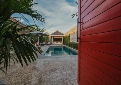 a red door leading to a pool in a house at Villa Bloom 5 close to the beach private pool 3 bedrooms 3 bathrooms in Seminyak