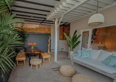 a living room with a couch and a table at Villa Bloom 5 close to the beach private pool 3 bedrooms 3 bathrooms in Seminyak