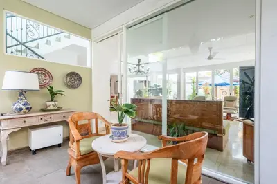 a living room with a table and chairs at AQ-VA Hotel & Villas Seminyak in Legian