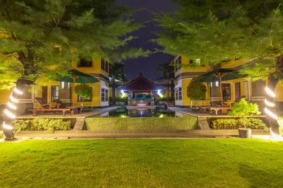 a house with a courtyard at night at Apel Villa Sanur in Sanur