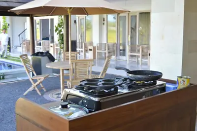 a frying pan on a stove in a patio at Tirtha Khayangan in Canggu