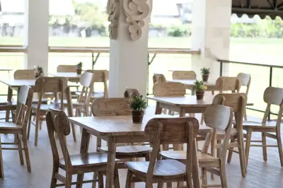 a group of tables and chairs in a restaurant at Tirtha Khayangan in Canggu