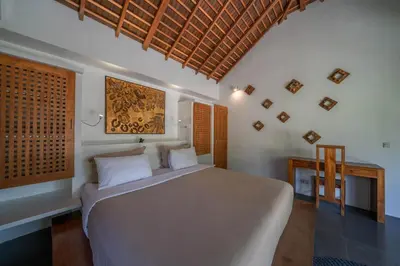 a bedroom with a large white bed in a room at Villa Teman - Luxury 4BR Villa in Central Seminyak - HUGE POOL in Seminyak