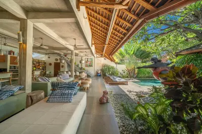 a living room with couches and a swimming pool at Villa Teman - Luxury 4BR Villa in Central Seminyak - HUGE POOL in Seminyak
